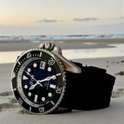 HAND-BUILT DIVERS WATCH HADAL showcasing a stainless steel case on a beach at sunset.