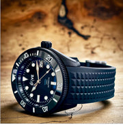 HAND-BUILT DIVERS WATCH HADAL NOIR on a textured surface with a black PVD steel case and rubber strap.